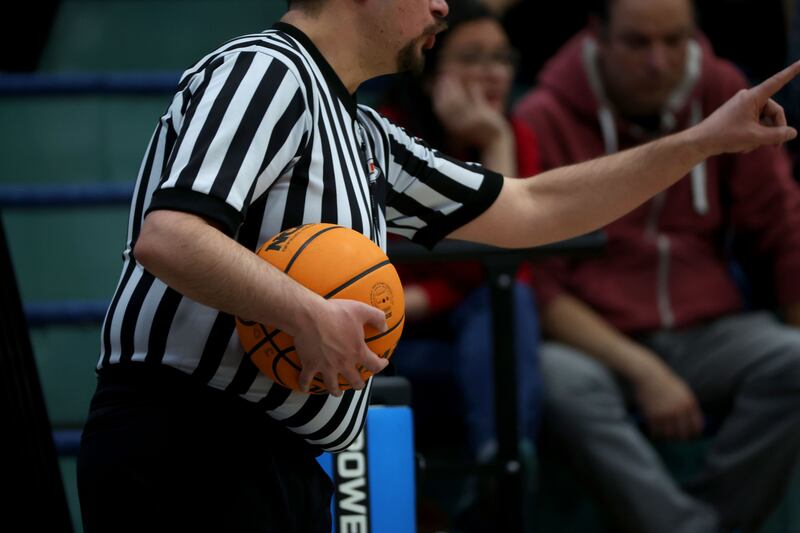 An official works a high school basketball game on Feb. 17, 2022.