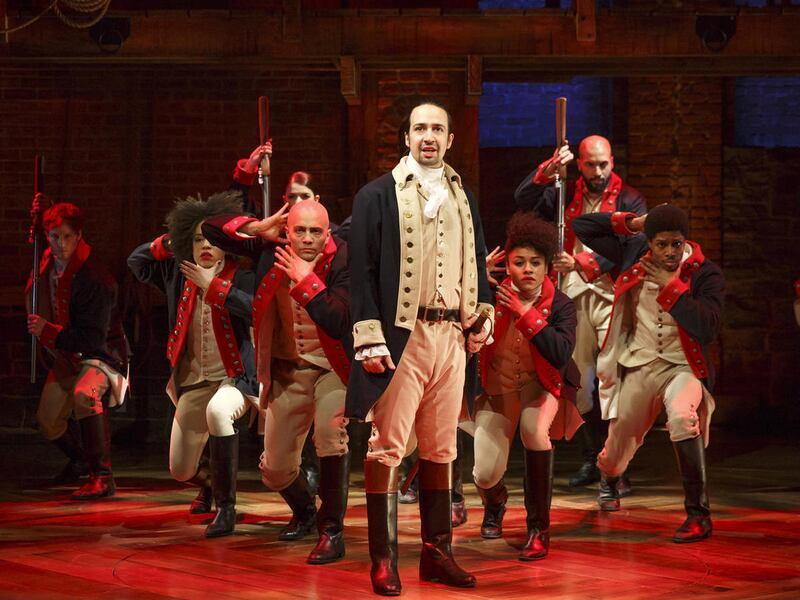 This image released by The Public Theater shows Lin-Manuel Miranda, foreground, with the cast during a performance of “Hamilton,” in New York.