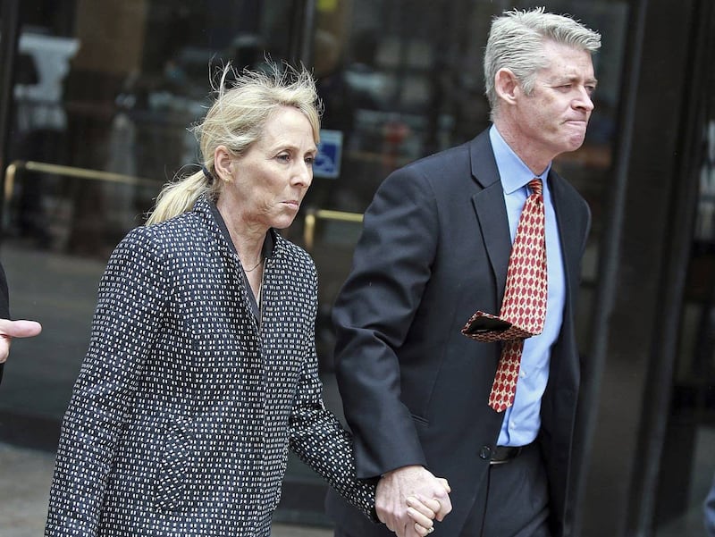 Elisabeth Kimmel, left, indicted in the college admissions scandal, leaves a Boston courthouse on Friday, March 29, 2019. She is accused of paying to have her two children accepted to college as athletes although they didn't participate on the teams. Does