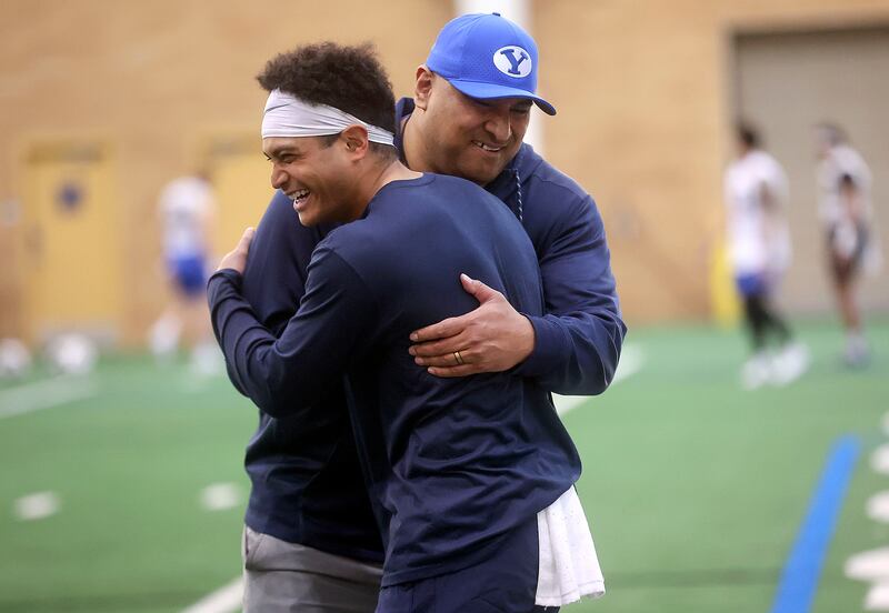 BYU coach Kalani Sitake hugs running back Sione Finau after practice in the Indoor Practice Facility at BYU in Provo.