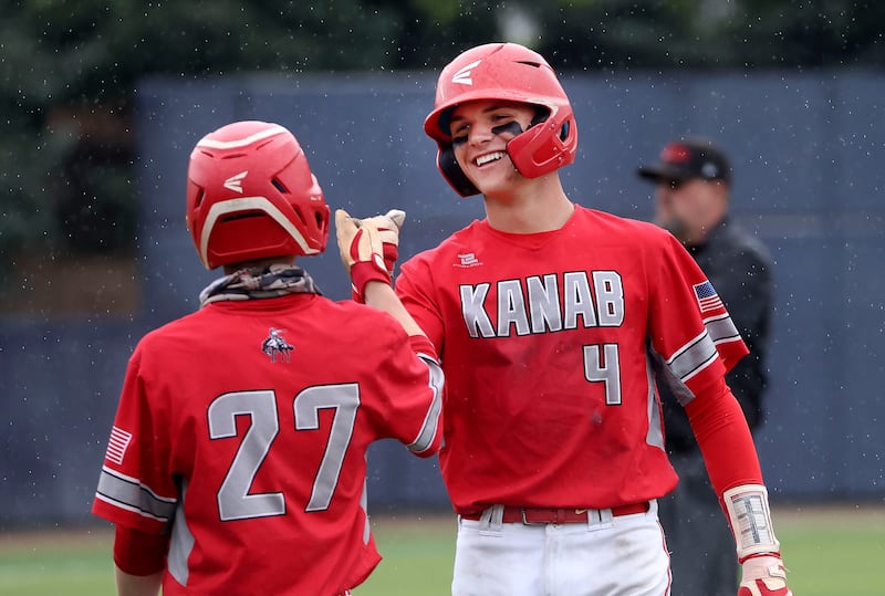 Kanab’s Griffin Bone fist bumps a teammate