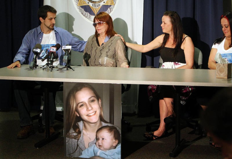 James Bakoles, left, and Adrien Koch, second from right, comfort their mother Nancie Bakoles during a press conference about the death of their sister and daughter Nikole Bakoles in 2012.