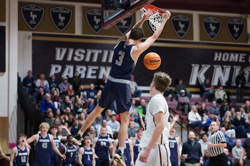 Corner Canyon’s Jaxon Roberts dunks in a high school boys basketball game.