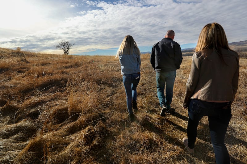 Spencer Cox, Utah governor, walks alongside his daughter, Emma Cate, on their Fairview farm with his wife, Abby, close behind. 