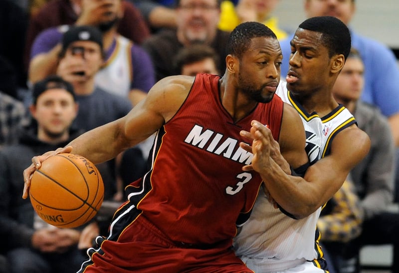Miami Heat shooting guard Dwyane Wade (3) tries to drive to the basket as Utah Jazz point guard Alec Burks (10) defends during a game at EnergySolutions Arena on Saturday, Feb. 8, 2014.