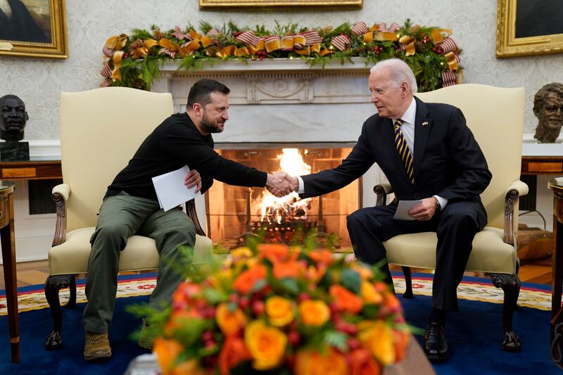President Joe Biden shakes hands with Ukrainian President Volodymyr Zelenskyy as they meet in the Oval Office of the White House, Tuesday, Dec. 12, 2023, in Washington.