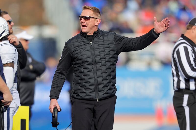 Utah State head coach Blake Anderson talks to players on the sideline against Boise State in the first half of an NCAA college football game, Friday, Nov. 25, 2022, in Boise, Idaho. Boise State won 42-23. (AP Photo/Steve Conner)