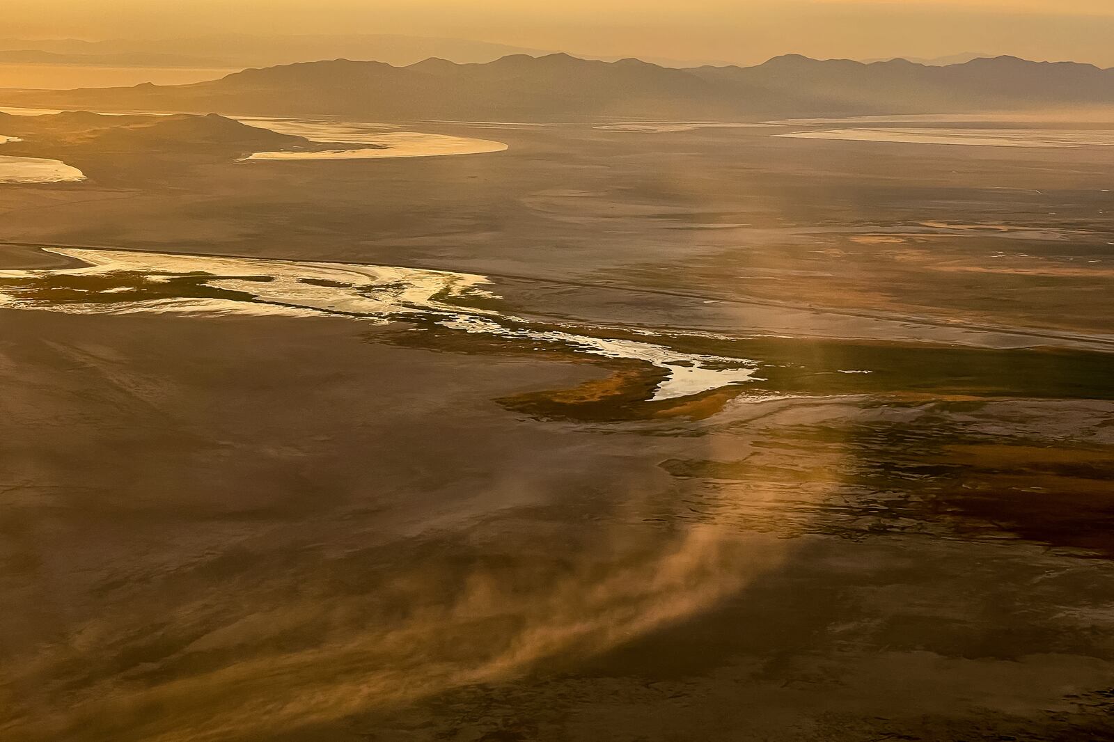 Dust blows across the dry lakebed of the Great Salt Lake near Salt Lake City on Friday, Aug. 12, 2022.