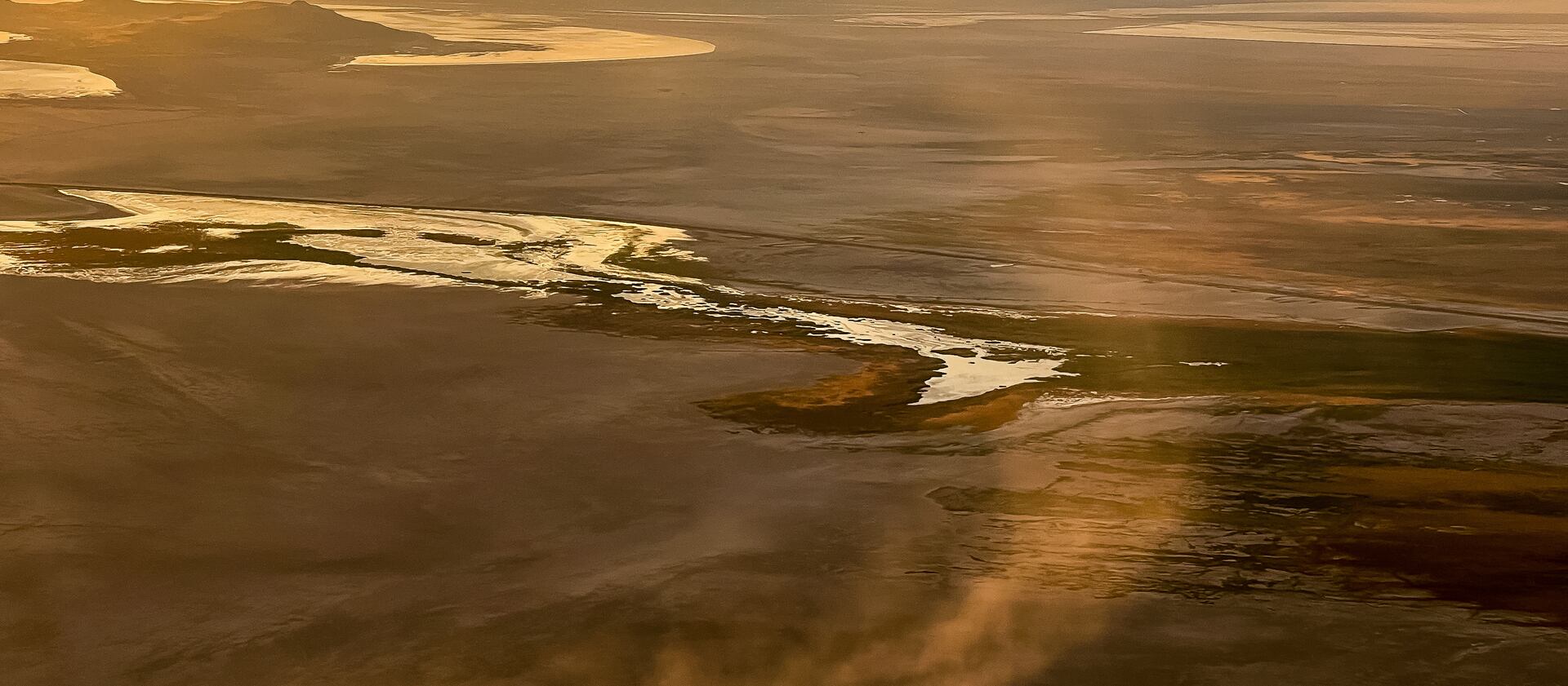 Dust blows across the dry lakebed of the Great Salt Lake near Salt Lake City on Friday, Aug. 12, 2022.