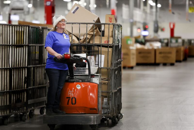 Yvette Allgood works at the United States Postal Service Priority Mail Center in Salt Lake City on Thursday. She said she loves how working for USPS lets her be a part of the magic of Christmas.
