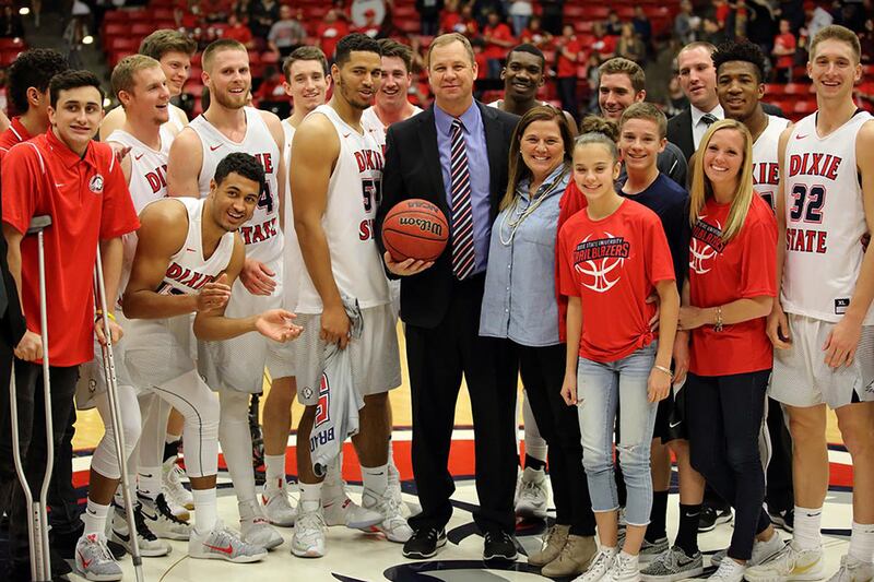 Jon Judkins (center) poses with his team and family after earning his 500th coaching victory Saturday night.