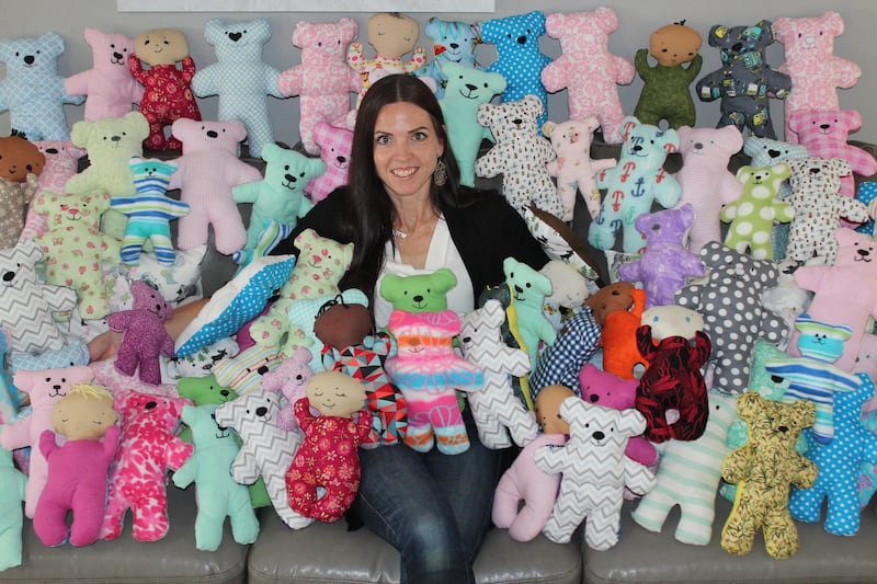 Sarah Carmichael Parson, founder of Dolls of Hope, poses with handmade bears. Since its creation in 2015, Dolls of Hope has donated over 9,000 handmade stuffed toys to children in need all around the world.