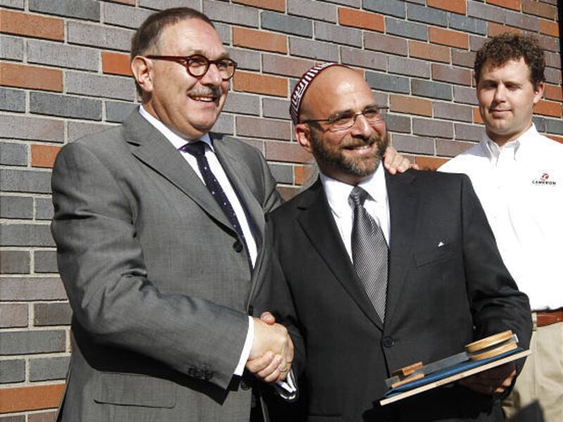 German architect Alfred Jacoby presents a ceremonial key to Rabbi Josh Aaronson at Temple Har Shalom in Park City.