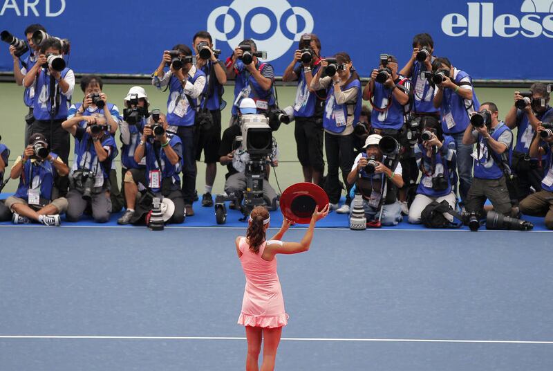 Agnieszka Radwanska of Poland holds up the trophy after her win over Vera Zvonareva of Russia1 in their final match at the Toray Pan Pacific Open women's tennis tournament in Tokyo Saturday, Oct. 1, 2011.