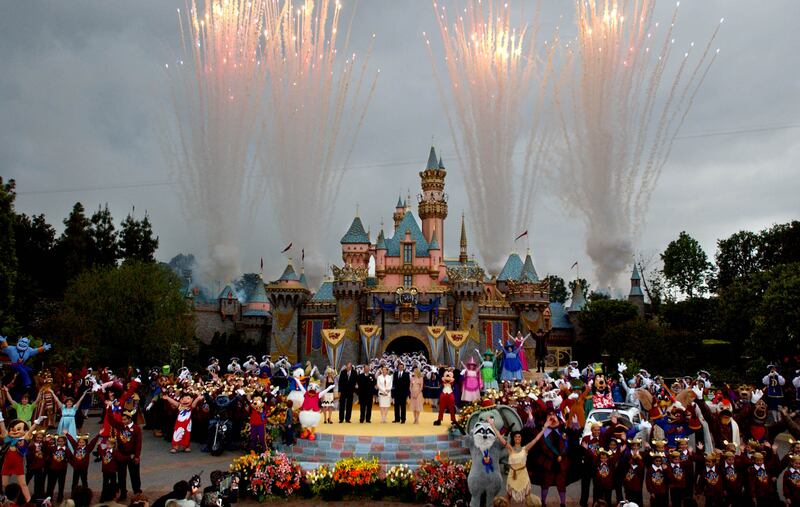 Disney executives, characters and guests stand in front of the refurbished Castle at Disneyland in Anaheim.