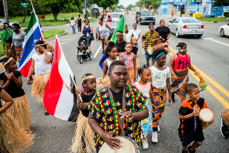 FILE - In this June 19, 2018, file photo, Zebiyan Fields, 11, at center, drums alongside more than 20 kids at the front of the Juneteenth parade in Flint, Mich. Juneteenth celebration started with the freed slaves of Galveston, Texas. Although the Emancip