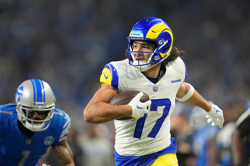 Los Angeles Rams receiver Puka Nacua runs toward the end zone for a touchdown during an NFL wild-card playoff football game.
