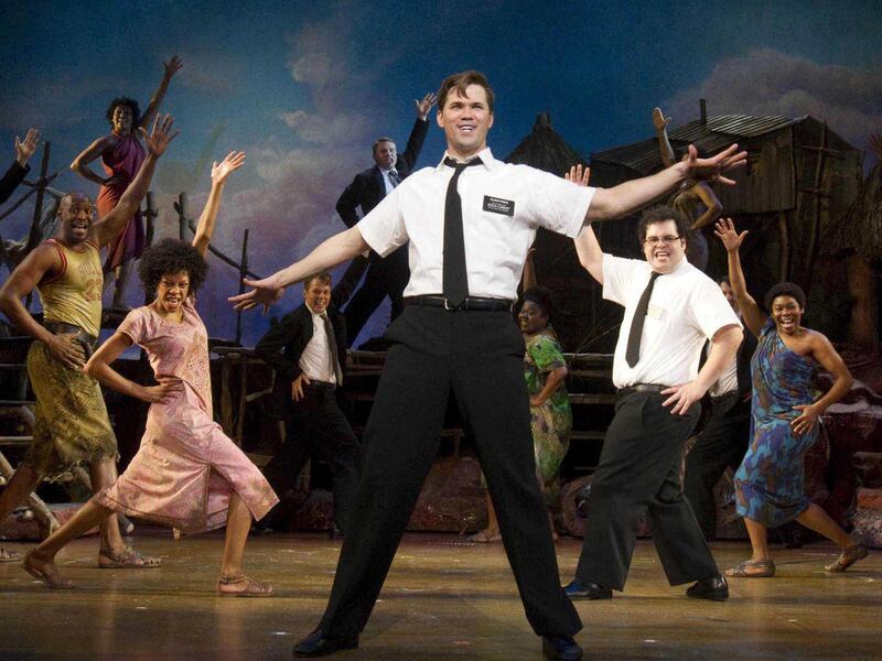 In this theater publicity image released by Boneau/Bryan-Brown, Andrew Rannells, center, performs with an ensemble cast in "The Book of Mormon" at the Eugene O'Neill Theatre in New York. The Broadway musical is nominated for 14 Tony Awards. The Tony Awar