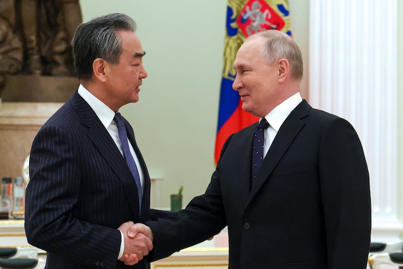 Russian President Vladimir Putin greets Chinese Communist Party’s foreign policy chief Wang Yi during in Moscow in 2023.