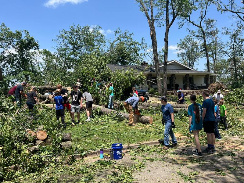 Latter-day Saints help clean trees and other debris after tornadoes on May 26, 2024, tore through Arkansas.
