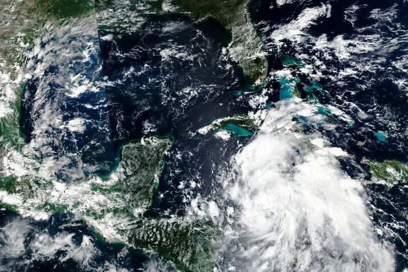 A satellite image released by NASA shows Hurricane Ian over Caribbean Sea moving near the Cayman Islands and closer to western Cuba.