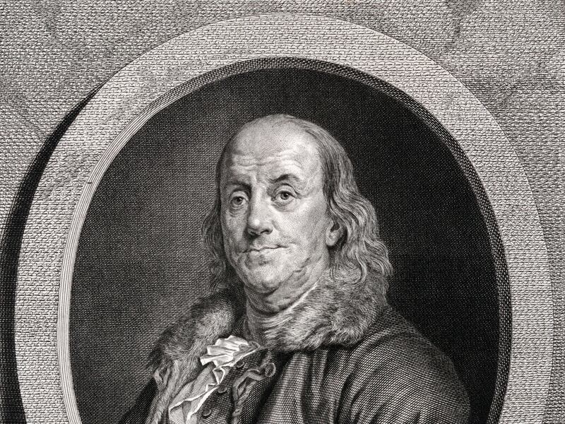 An engraved image of Benjamin Franklin.