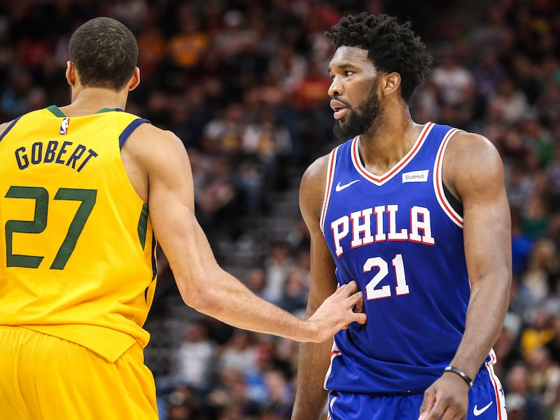 Utah Jazz center Rudy Gobert (27) defends against Philadelphia 76ers center Joel Embiid (21) in an NBA basketball game at Vivint Arena.