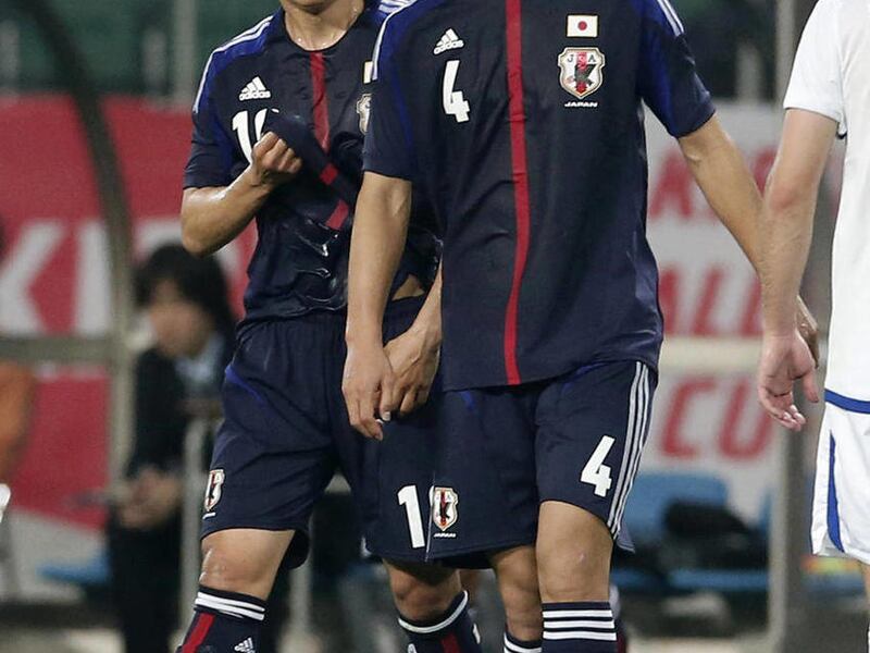 In this May 23, 2012 photo, Japan’s Shinji Kagawa, left, and teammate Keisuke Honda walk on the pitch during their international friendly soccer match against Azerbaijan at Ecopa Stadium in Shizuoka, central Japan. Japan coach Alberto Zaccheroni will rely