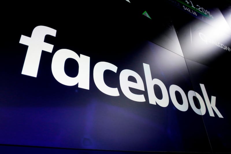 FILE - In this March 29, 2018, file photo, the logo for Facebook appears on screens at the Nasdaq MarketSite in New York's Times Square. Myanmar’s powerful military chief is among 20 individuals and organizations that Facebook says it is banning from its