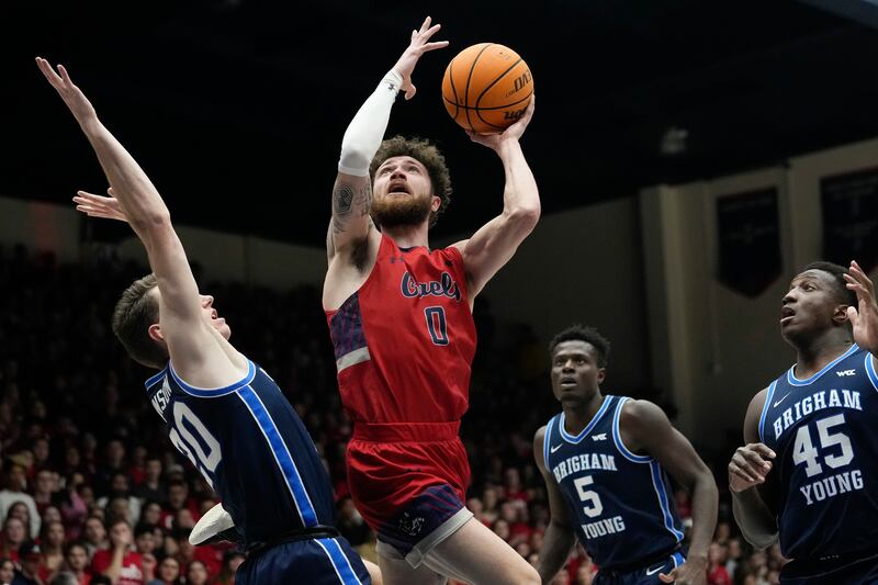 Saint Mary’s guard Logan Johnson (0) shoots while defended by BYU guard Spencer Johnson, left, during the first half of an NCAA college basketball game in Moraga, Calif., Saturday, Feb. 18, 2023.