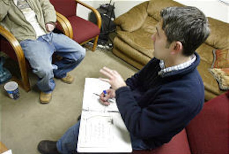 Reynie Sandoval, a therapist at The Gathering Place, counsels with a patient. He said a mark of success is seeing parent-child relationships improve.