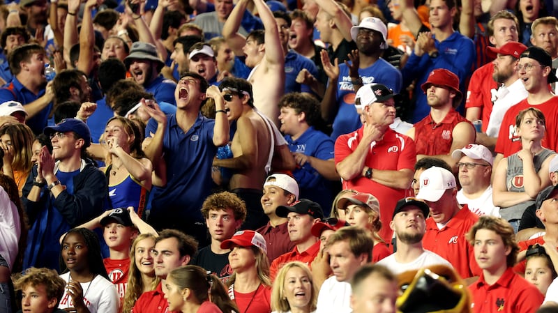 Gator fans cheer as Utah Utes fans show disappointment after a Gator score as Utah and Florida play in Gainesville, Fla.