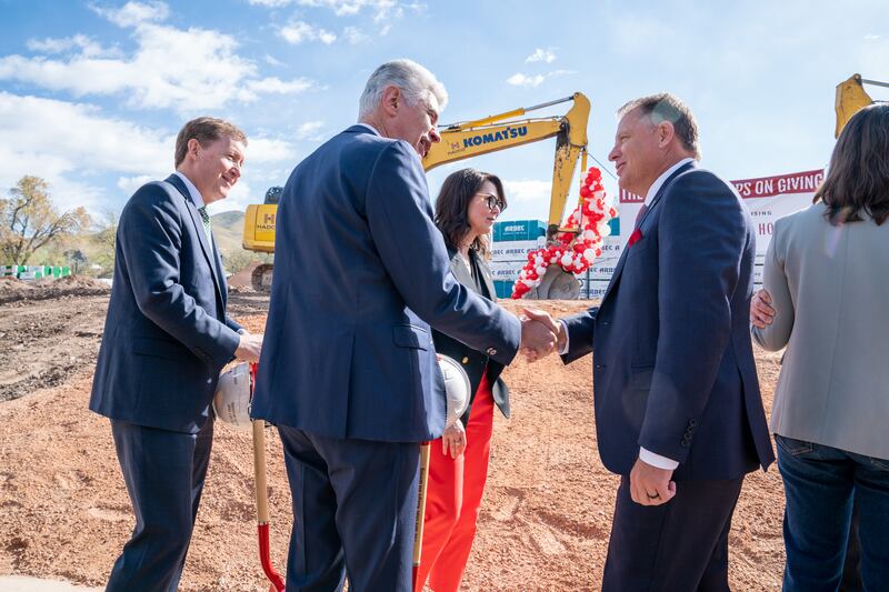 Presiding Bishop Gérald Caussé shakes hands with University of Utah President Taylor Randall, right, at Ivory University House.