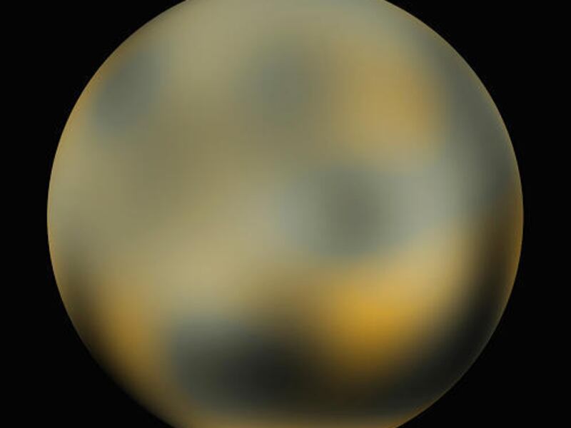 This undated handout photo provided by NASA, taken by NASA's Hubble Space Telescope, shows the dwarf planet Pluto.The image shows an icy, mottled, dark molasses-colored world undergoing seasonal surface color and brightness changes.