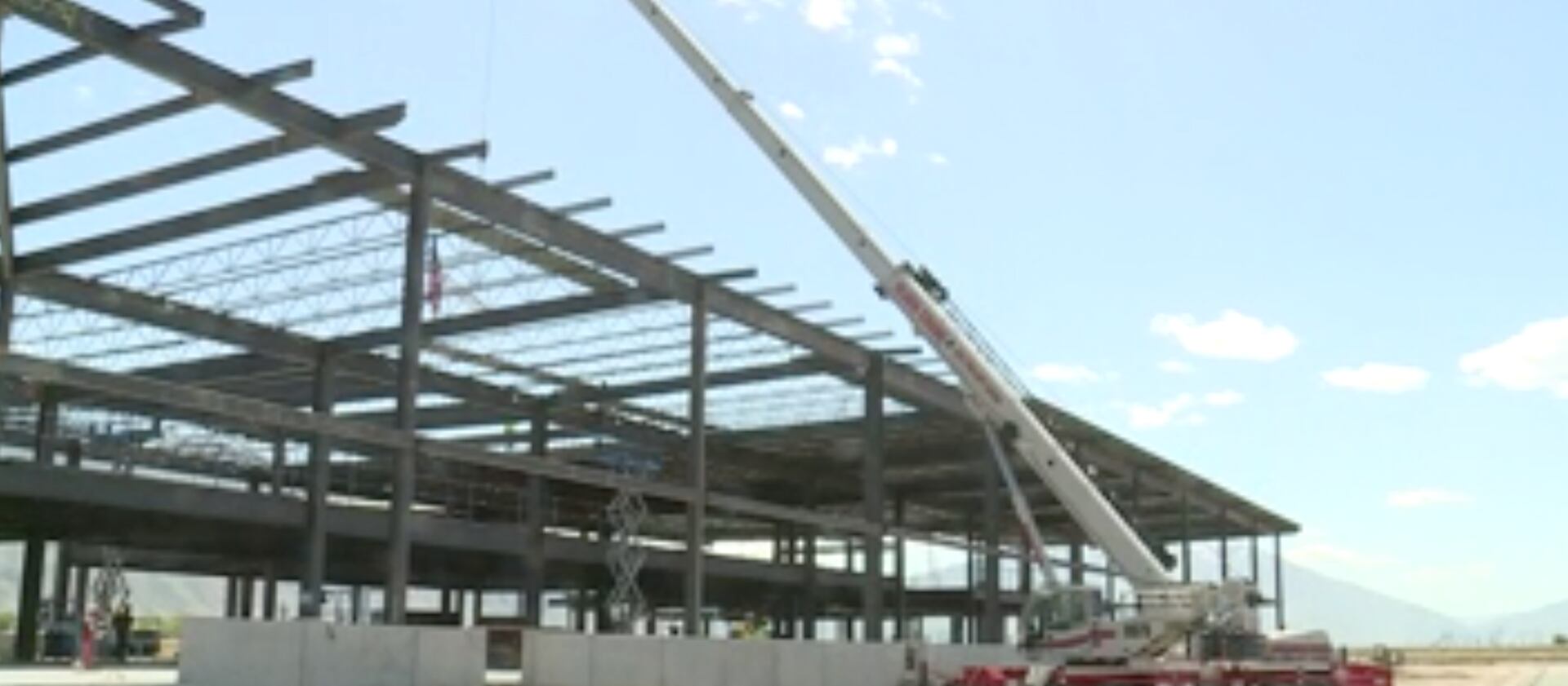 A crane hoists the highest beam of the new Provo Municipal Airport terminal into place on Thursday, May 20, 2021.