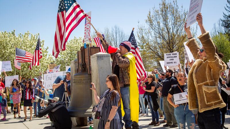 Protesters gather near the Idaho Statehouse on Friday, April 17, 2020, in Boise, Idaho, in defiance of Gov. Brad Little’s extension of the statewide stay-at-home order. Little announced Wednesday that the order would extend to the end of April in the effort to slow the spread of coronavirus, although he lightened some restrictions so nonessential businesses could begin providing curbside service. (Katherine Jones/Idaho Statesman via AP)