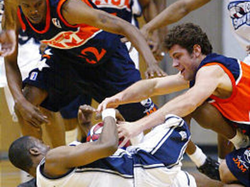 Utah Snowbear's Tyrone Hayes fights for a ball with the Long Beach Jam's Nick Vanderlaan (55) and Jeremee McGuire during the Snowbears' victory on Wednesday.
