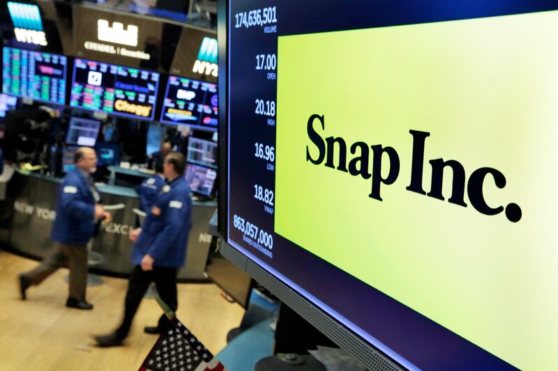 The logo for Snap Inc. appears above a trading post on the floor of the New York Stock Exchange, Wednesday, Feb. 7, 2018. Nearly a year after its initial public offering and lackluster growth, the company behind Snapchat is making a comeback, calming inve