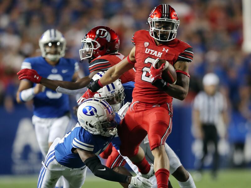 BYU Cougars defensive back Isaiah Herron brings down Utah Utes running back Micah Bernard as BYU and Utah play in 2021.