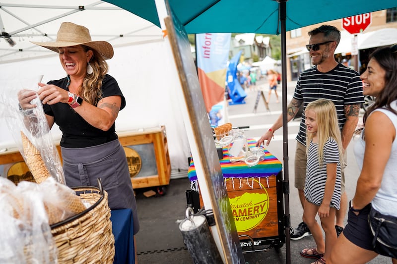 Kris May, owner of Wasatch Creamery Ice Cream Company, left, serves T.J. Stevenson, Esmé Stevenson and Jessica Privett, left to right, of Salt Lake City, at the Kimball Arts Festival in Park City on Saturday, Aug. 3, 2019.