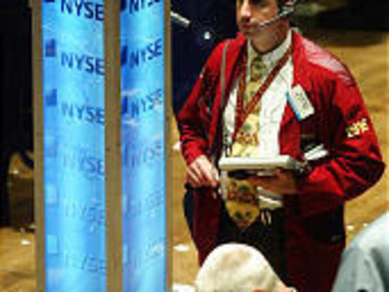 NYSE traders work at the end of the day burdened with disappointments from Microsoft and Amazon.com.
