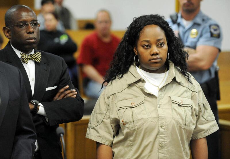 FILE - In this April 27, 2011 file photo, Tanya McDowell, right, stands during her arraignment on larceny charges in Norwalk, Conn., Superior Court, Wednesday April 27, 2011. McDowell's attorney Darnell Crosland, left, stands with her. McDowell, a homele