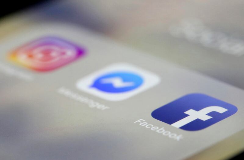 FILE- In this March 13, 2019, file photo Facebook, Messenger and Instagram apps are are displayed on an iPhone in New York. Facebook said Wednesday, March 27, that it is broadening its definition of hate speech to apply to "white nationalists" and "white