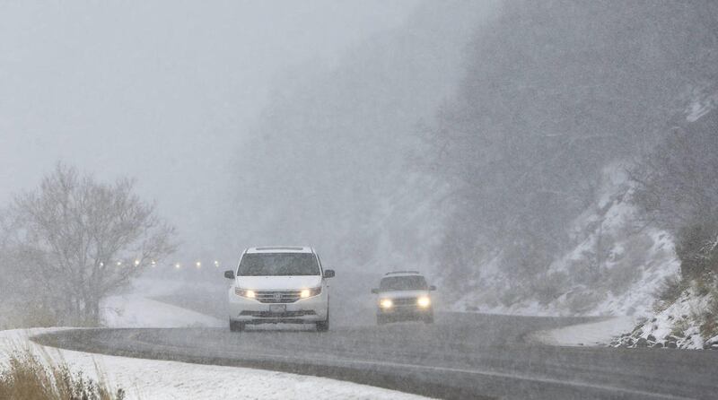 Motorists drive through the heavy snow in Little Cottonwood Canyon near Snowbird Ski Resort in Salt Lake County Thursday, March 27, 2014.