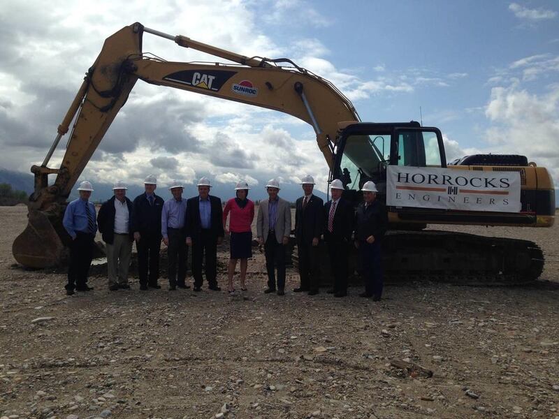 Dignitaries and invited guests pose in front of a trackhoe at the groundbreaking of the new Provo Westside Connector road in Provo, Thursday, May 8, 2014.