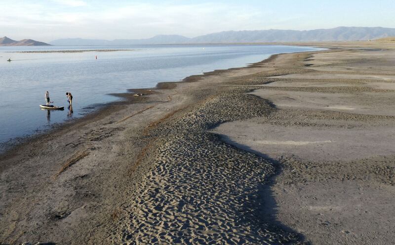Paddle boarders leave the water at the Great Salt Lake State Park in Salt Lake City on June 10, 2022.
