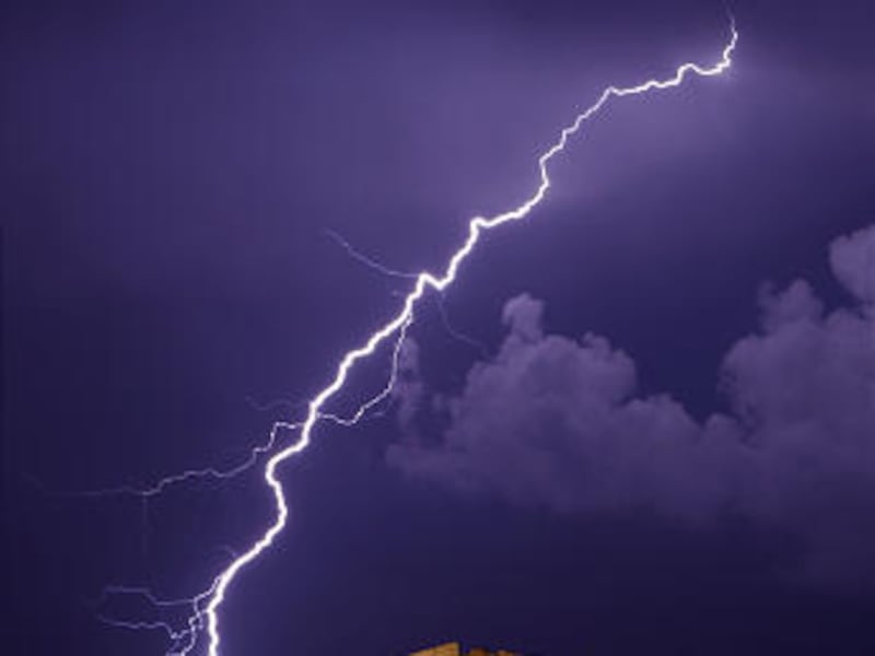 A flash of lightning streaks across the sky over the 2,500-year-old ancient Parthenon temple, on the Acropolis hill during heavy rainfall in Athens, early Monday morning.