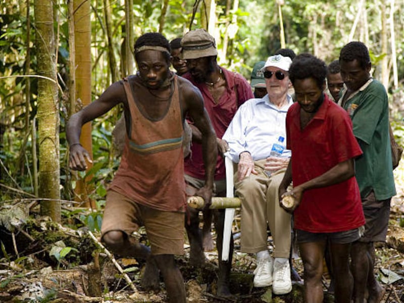 Fred Hargesheimer, at age 90 in July 2006, is carried by islanders in Papua New Guinea. Hargesheimer says he's "so grateful for getting shot out of the sky" in 1943. He built two schools, libraries, clinic.