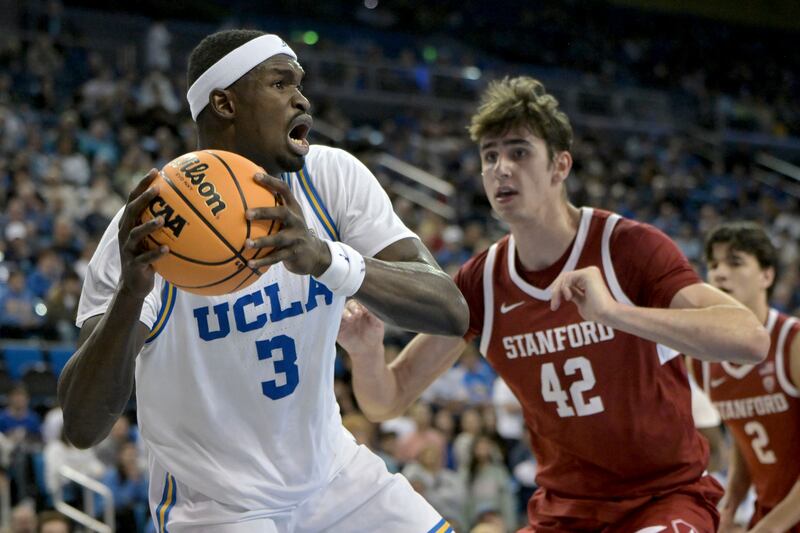 UCLA forward Adem Bona, left, is defended by Stanford forward Maxime Raynaud during an NCAA college basketball game Wednesday, Jan. 3, 2024, in Los Angeles.
