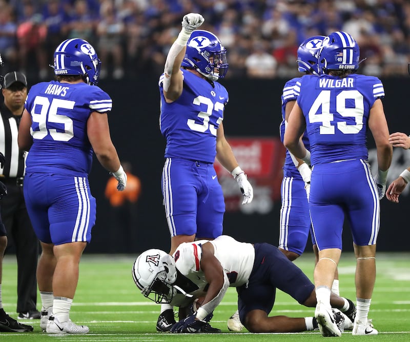 BYU linebacker Ben Bywater calls a play after a tackle during the Vegas Kickoff Classic in Las Vegas on Sept. 4, 2021.